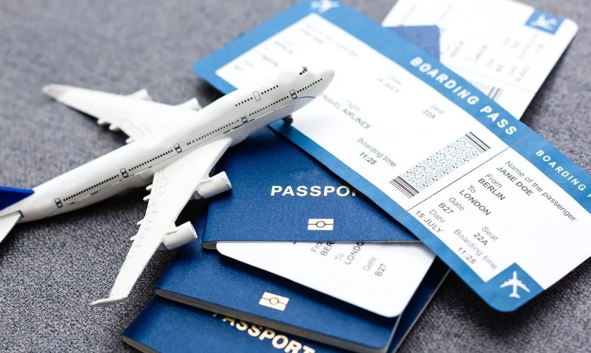 Flight tickets, passports and airplane for flight booking