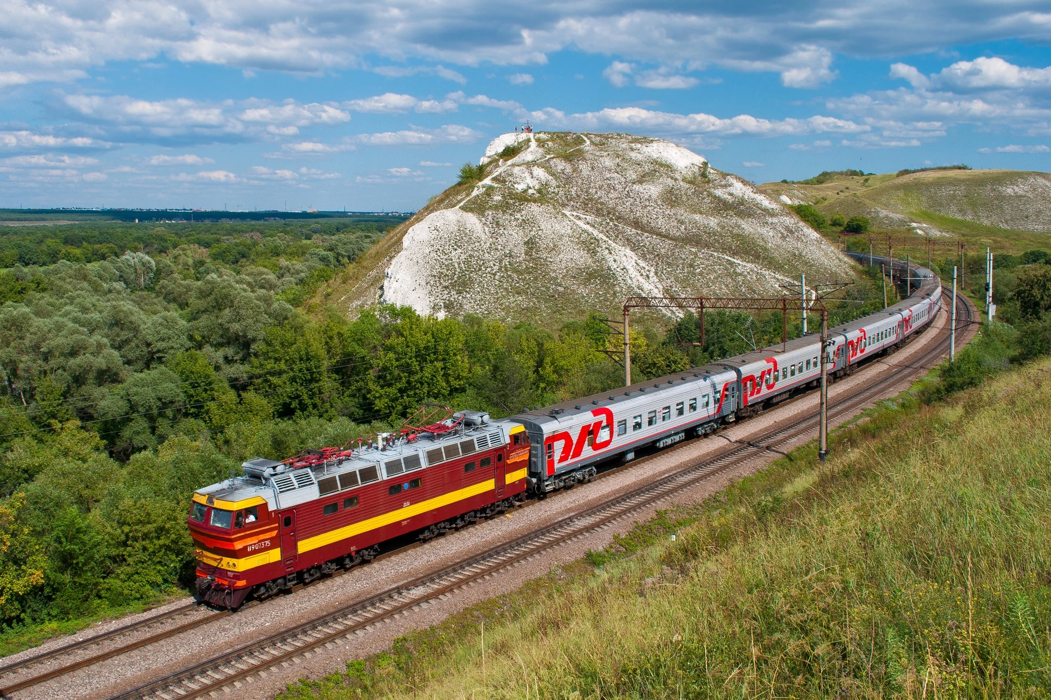 Train travelling through a scenic mountain landscape